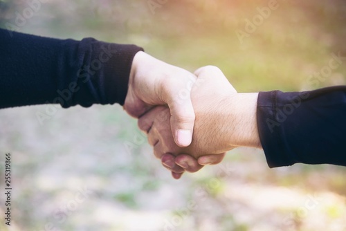 Man touching / holding hand together for success commitment work concept