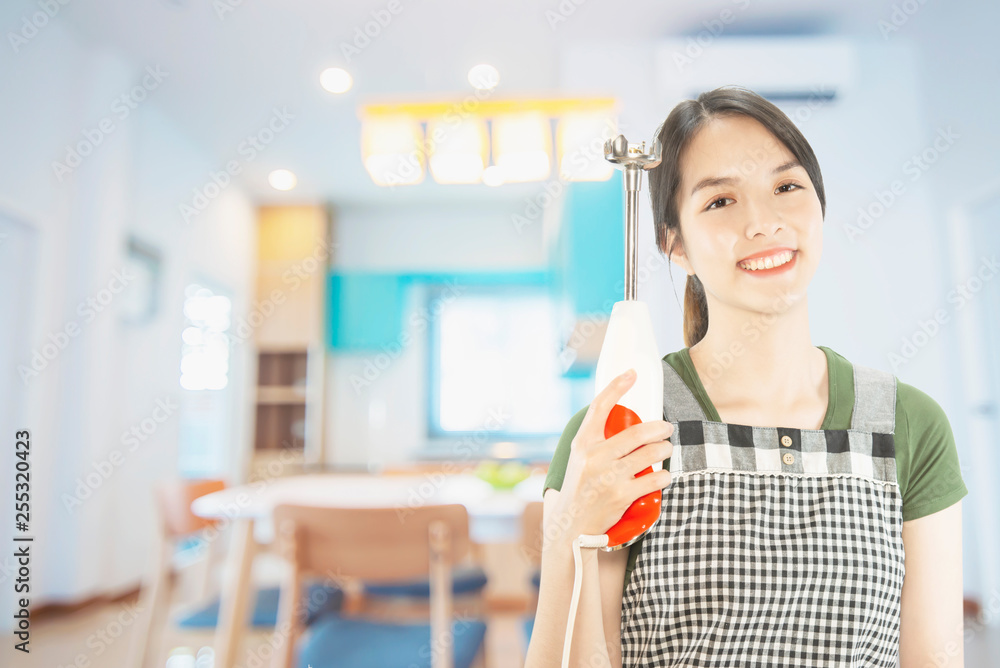Happy lady holding kichen stuff over copy space background - people home made food preparation concept Happy lady holding kichen stuff over copy space background - people home made food preparation concept