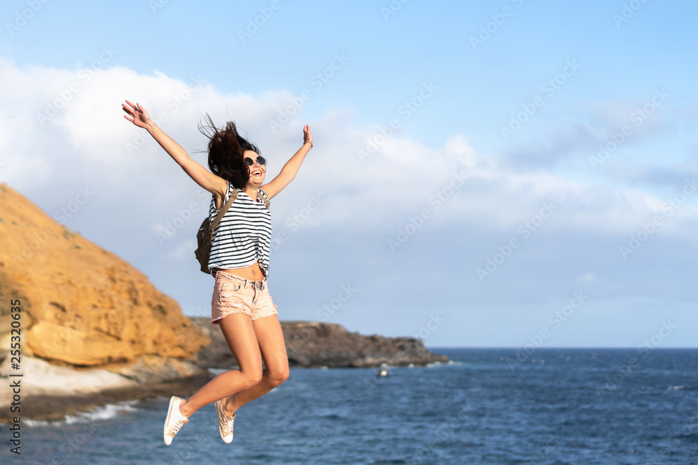 Pretty tourist brunette girl having fun outdoor near sea.