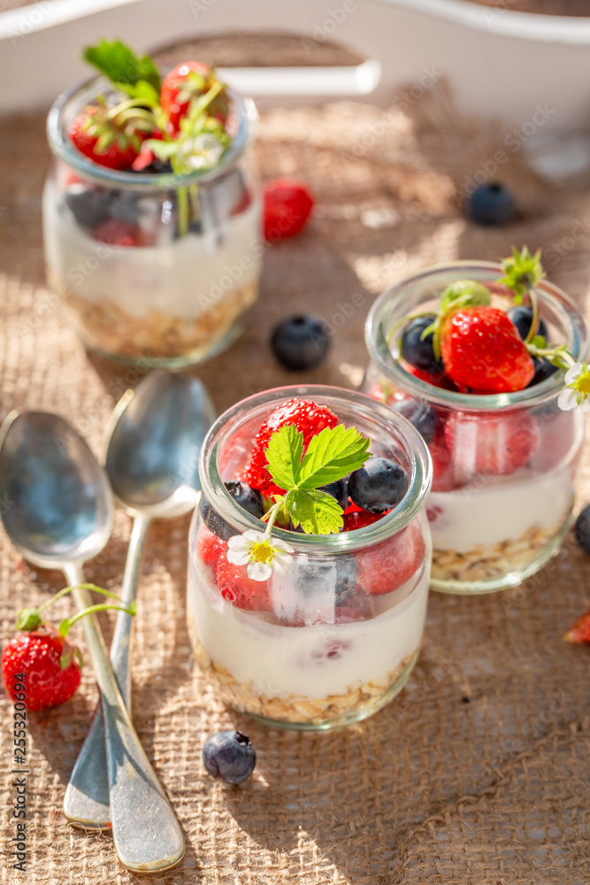 Delicious oat flakes in jar with yoghurt and berries Delicious oat flakes in jar with yoghurt and berries