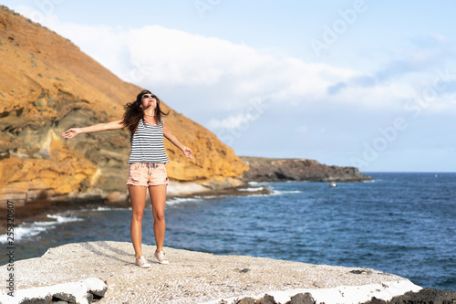 Pretty tourist brunette girl having fun outdoor near sea.
