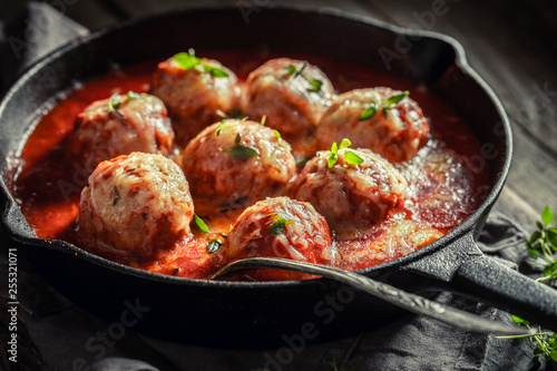 Tasty meatballs with tomato sauce and cheese