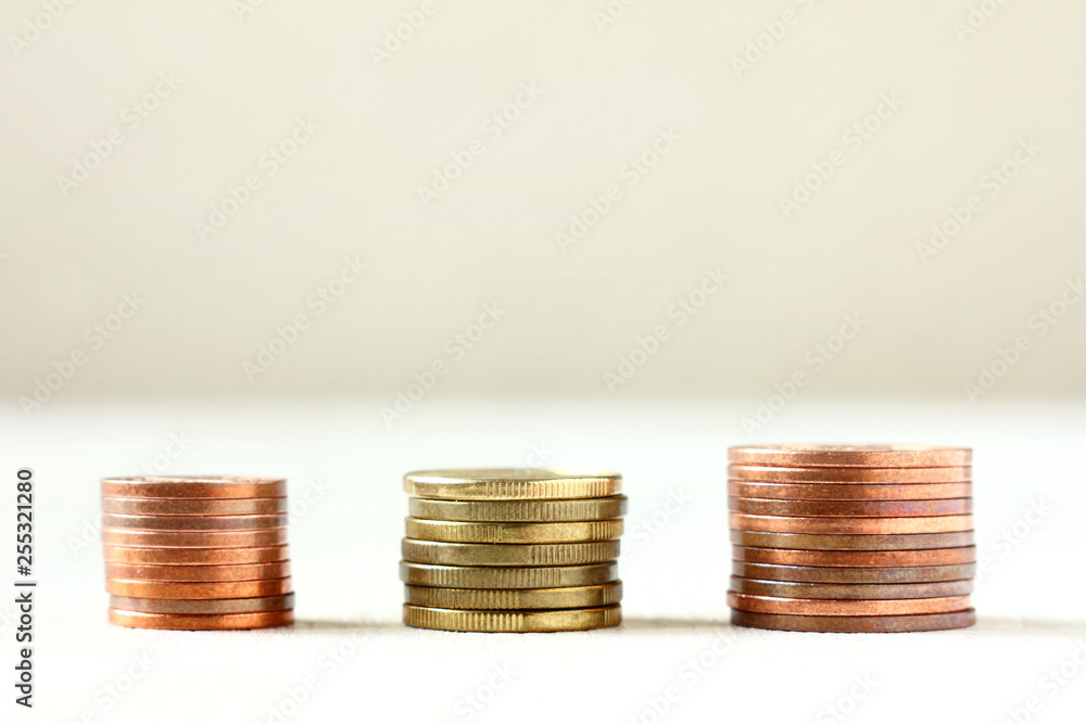 three piles of coins of different face values front view . size matters three piles of coins of different face values front view . size matters