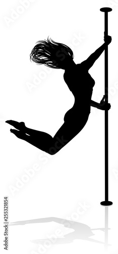 A woman pole dancer exercising for fitness in silhouette
