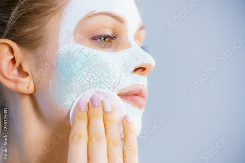 Girl removes dry white mud mask © anetlanda