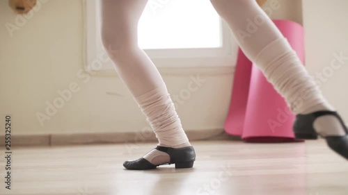  image of close-up feet of ballerina practicing