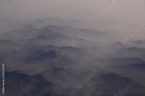Tableau sur toile The tops of the mountains in the fog