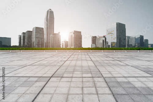 Urban skyscrapers with empty square floor tiles © 昊 周