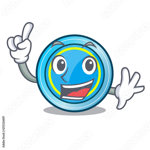 Finger frisbee next a wooden cartoon table