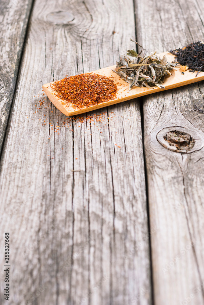 tea crops on bambbo serving tray on old rusty wooden table tea crops on bambbo serving tray on old rusty wooden table