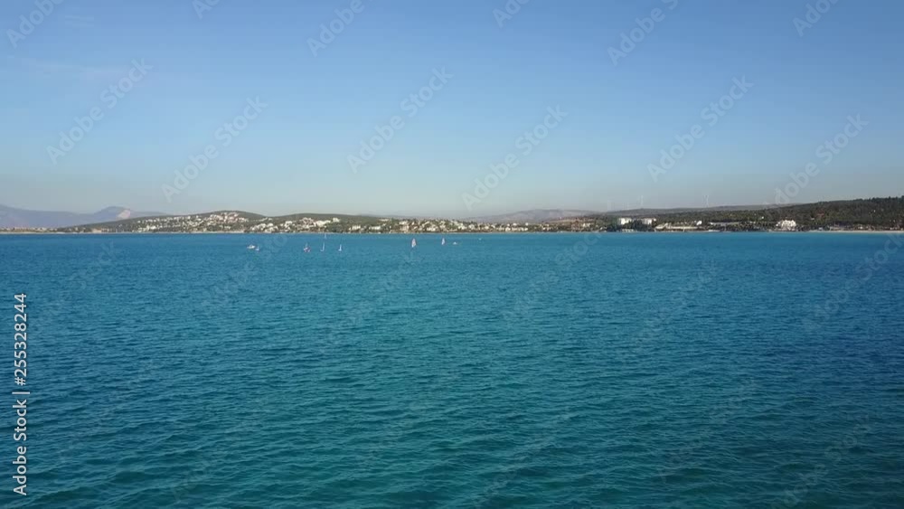 Aerial view from the seaside view of Cesme peninsula, Turkey, us01, drone footage, surfers and sailer on the sea Aerial view from the seaside view of Cesme peninsula, Turkey, us01, drone footage, surfers and sailer on the sea