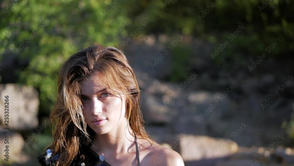 Portrait of young long-haired brunette caucasian girl in a shiny fashion T-shirt of sequins Portrait of young long-haired brunette caucasian girl in a shiny fashion T-shirt of sequins