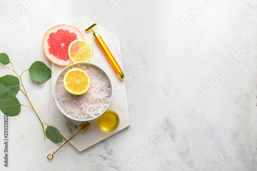 Ingredients for facial mask with massage tool on light background
