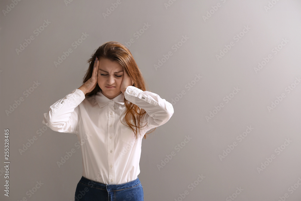Stressed girl after failing school test on grey background Stressed girl after failing school test on grey background