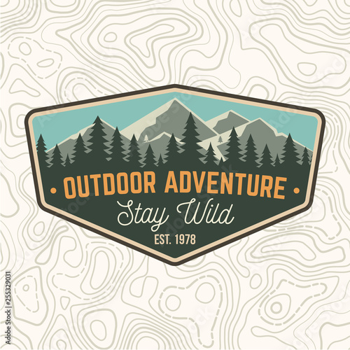 Stay wild, outdoor adventure patch. Vector. Concept for shirt or print, stamp or tee. Vintage typography design with mountains and forest silhouette. Outdoor adventure badge.