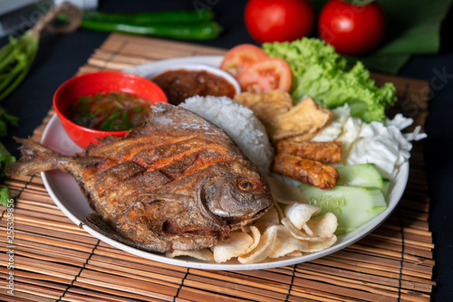 Fried pomfret fish and rice photo