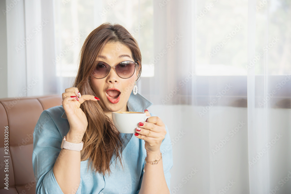 Portrait happy young Asian lady in coffee shop - woman in relax time concept Portrait happy young Asian lady in coffee shop - woman in relax time concept