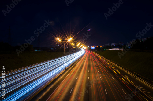 night highway. oiled lights of the night city. long exposure of car lights. night traffic