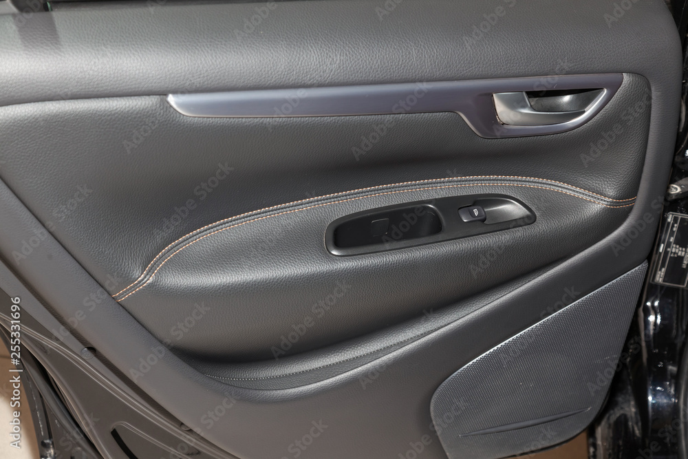 Close-up on door panel in the interior of an modern european car in black after dry cleaning