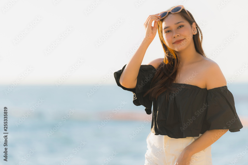 Portrait beautiful young asian woman happy and smile on the beach sea and ocean Portrait beautiful young asian woman happy and smile on the beach sea and ocean