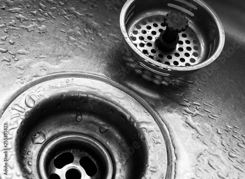 Close up of sink drain with water droplets