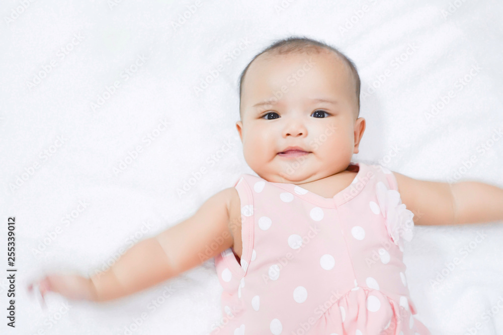 Asian newborn baby girl lying down on white bed Asian newborn baby girl lying down on white bed