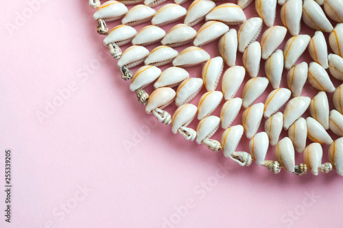 Beautiful summer cowrie shells on pink background photo