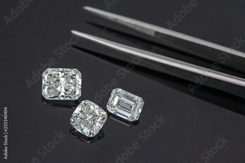 Multi shape of fancy diamonds with tweezers on black background © pv