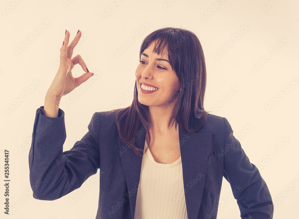 Portrait of a young beautiful smiling business woman doing O.K. sign. Isolated on white background Portrait of a young beautiful smiling business woman doing O.K. sign. Isolated on white background