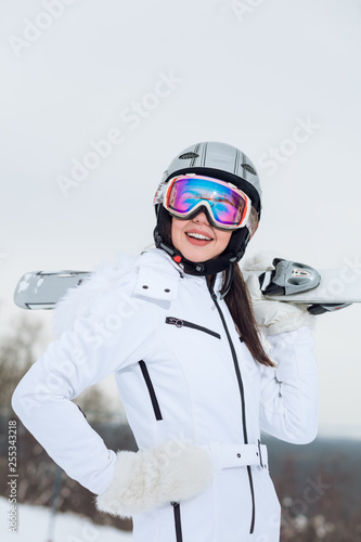 gorgeous woman in white stylish outfit spending a great time at ski resort, close up photo, © alfa27