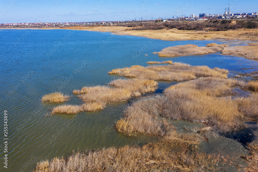 Top view of the coastal zone of the ecological reserve Kuyalnik estuary, Odessa, Ukraine. Aerial view from drone to sea estuaries in a suburban area near urban buildings