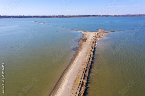 Off-piste. Deep rubber tracks on the road is covered with wet dirty sand  off-road. Traces of tires in the dirt. Impassable road for motocross and autosport. Wheel tracks on the sand