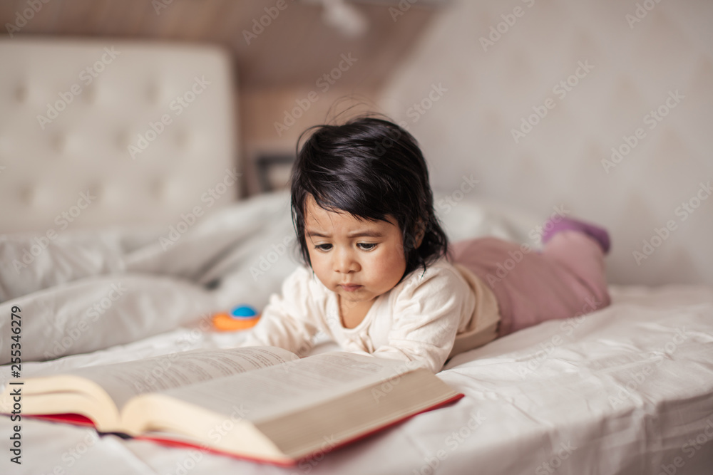 little cute girl enjoys reading a book. close up photo free time, hobby, lifestyle, childhood little cute girl enjoys reading a book. close up photo free time, hobby, lifestyle, childhood