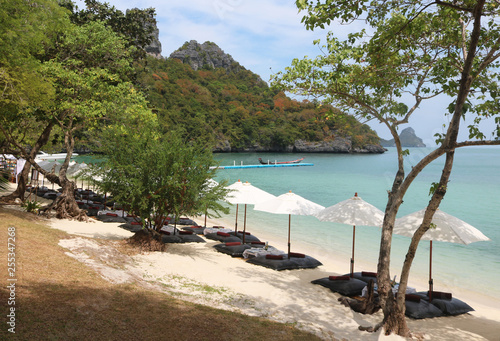 Bean bags with the white umbrella on the beach, set up for lunch at tropical island