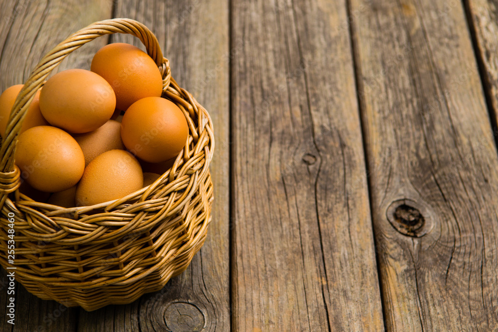 basket of eggs on old wooden background basket of eggs on old wooden background