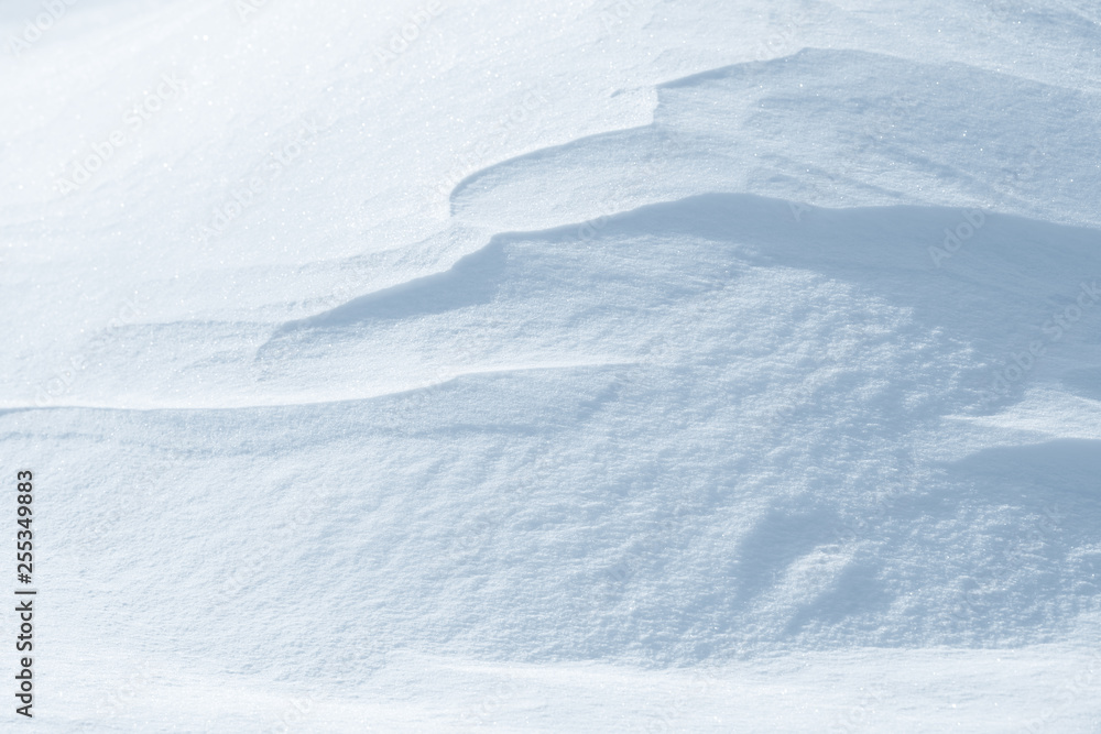 Fresh snow background texture. Winter background with snowflakes and snow mounds. Snow lumps.