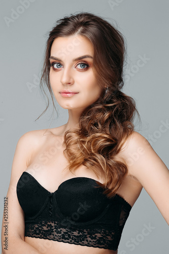 Wallpaper Mural Portrait of thoughtful sensual girl touching nice long hair. Beautiful fashionable lady with beautiful stylish hairdo and delicate makeup in lingerie. Isolated on gray background Torontodigital.ca