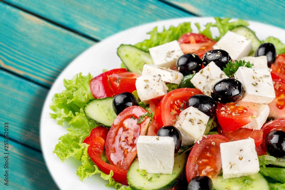 Greek salad with fresh vegetables on background Greek salad with fresh vegetables on background