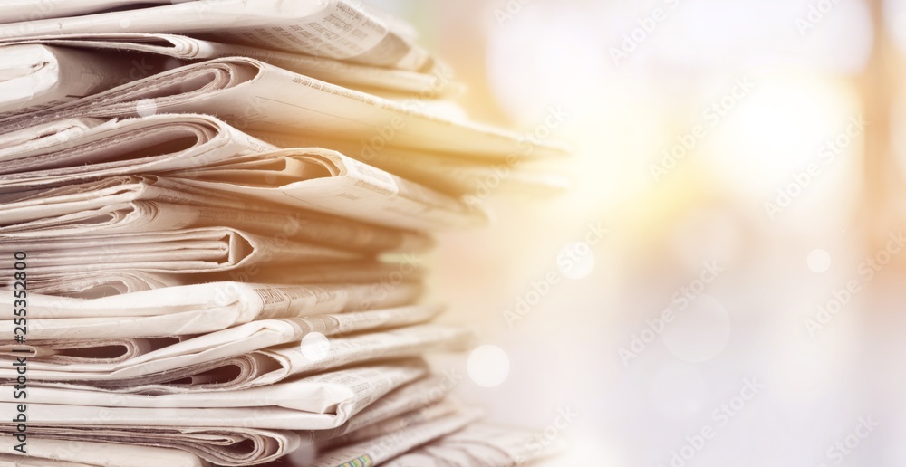 Pile of printed newspapers on background