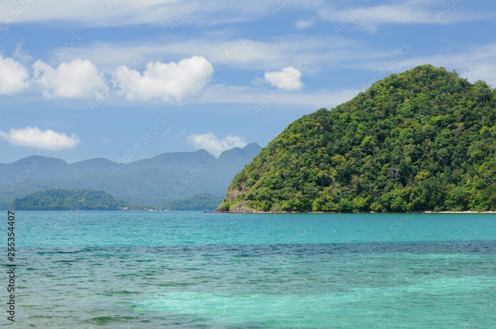 Turquoise tropical sea with mountains on horizon on Koh Chang island, Thailand.
