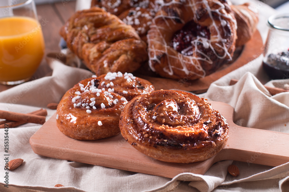 Fresh pastries for Breakfast on a wooden Board. Wooden background Fresh pastries for Breakfast on a wooden Board. Wooden background
