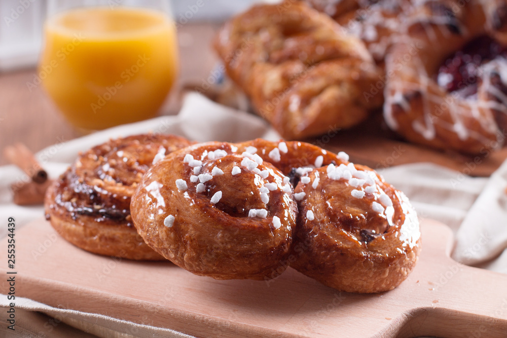 Fresh pastries for Breakfast on a wooden Board. Wooden background