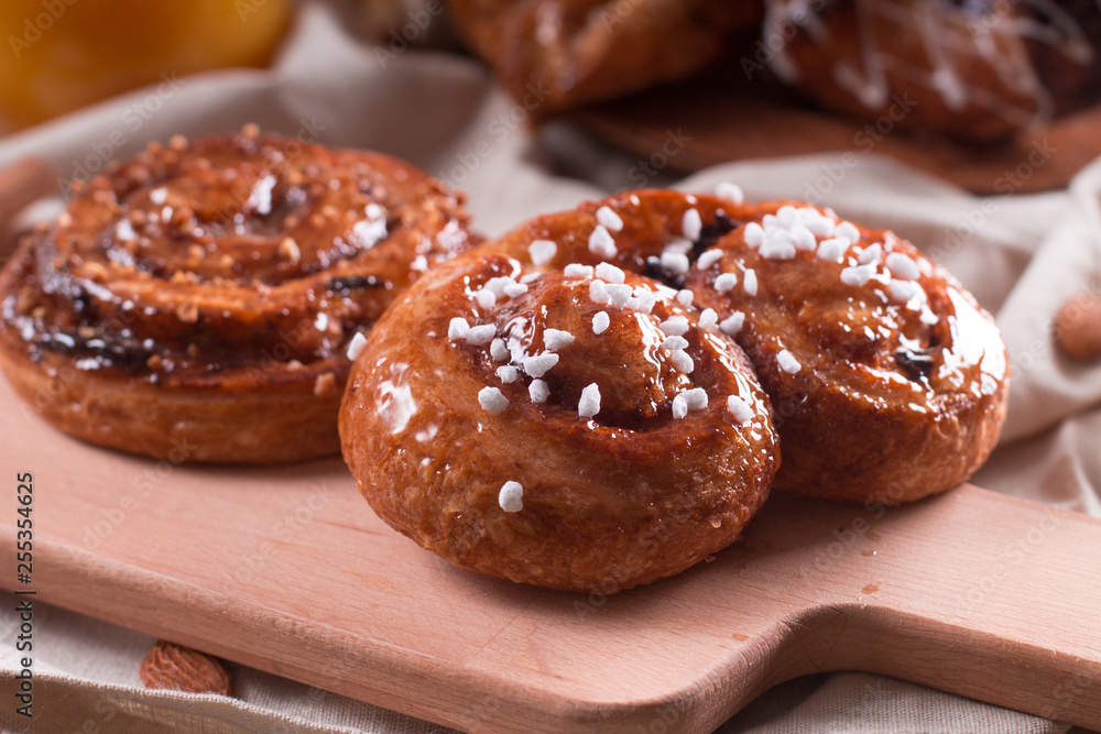 Fresh pastries for Breakfast on a wooden Board. Wooden background