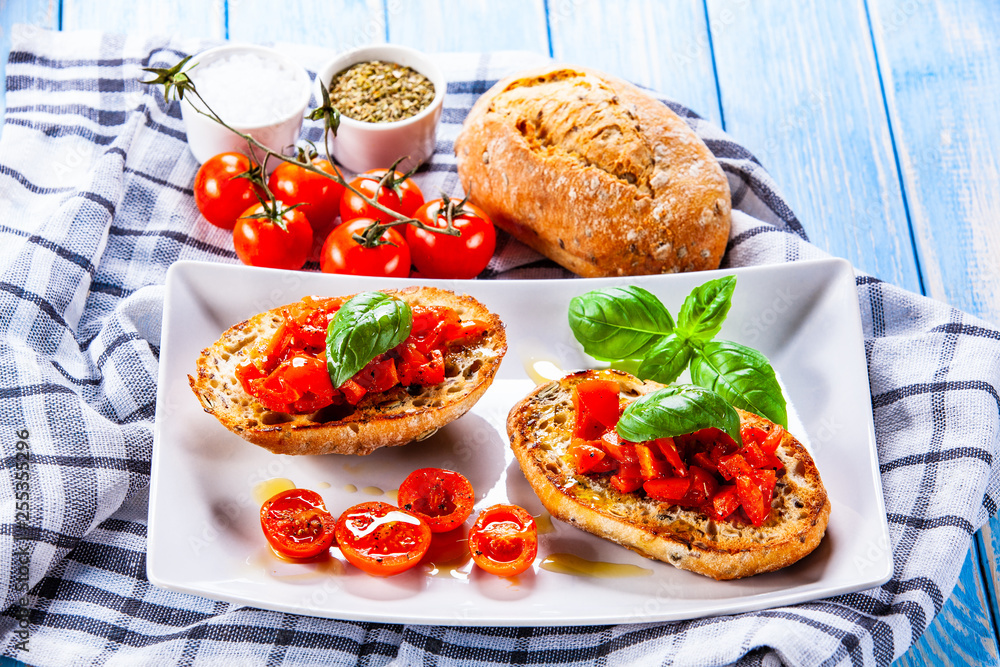 Bruschettas on white plate on wooden background Bruschettas on white plate on wooden background