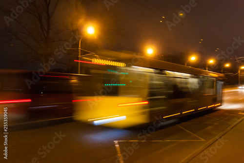  The motion of a blurred bus on the avenue in the evening. 