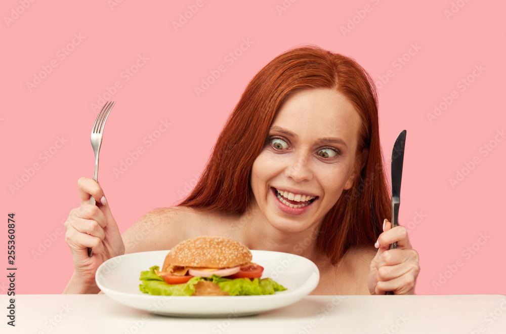 Diet failure of emaciated skinny redhead woman feeling excitement and joy when is going to eat unhealthy food hamburger. Diet failure of emaciated skinny redhead woman feeling excitement and joy when is going to eat unhealthy food hamburger.