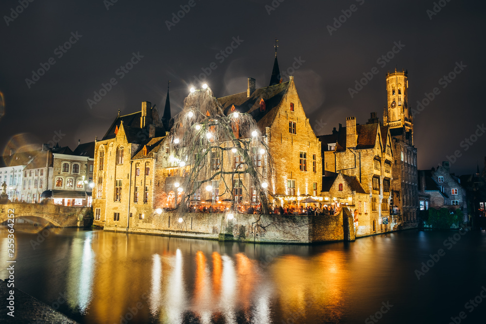 famous landmark near the river in Bruges, at night, Belgium