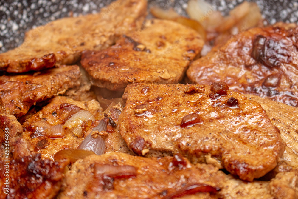 Cooking fryed meat on the pan with onion close up Cooking fryed meat on the pan with onion close up