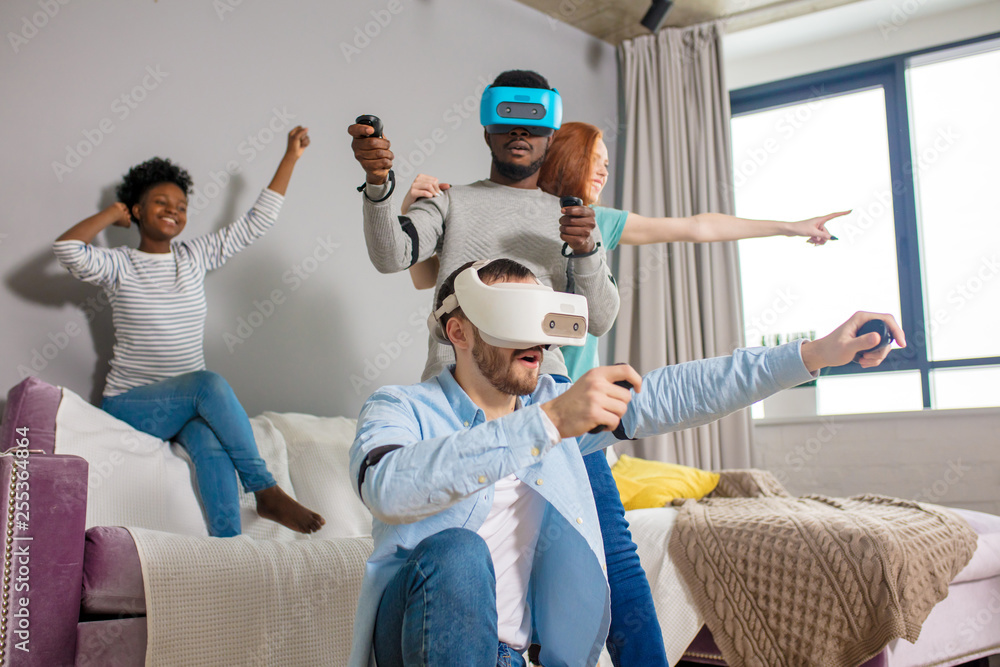 Virtual Games Using Vr Group of multiracial male amd female students playing virtual game ...