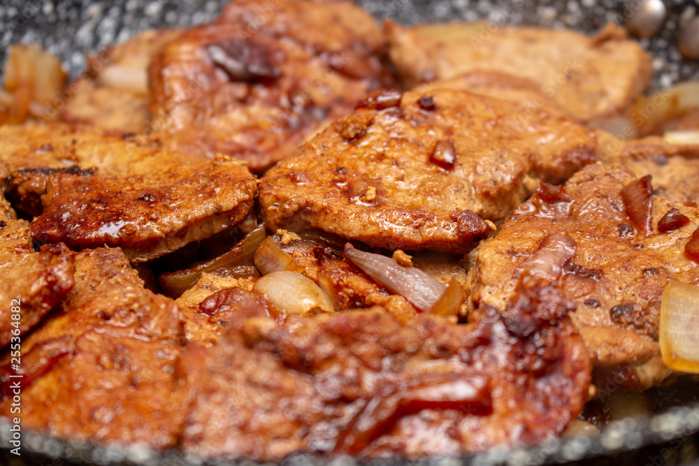 Cooking fryed meat on the pan with onion close up Cooking fryed meat on the pan with onion close up